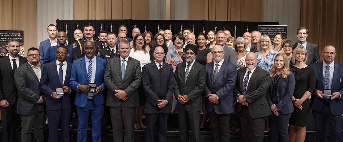 The Honourable Harjit S. Sajjan, President of the King's Privy Council for Canada and Minister of Emergency Preparedness (far left) and Minister responsible for the Pacific Economic Development Agency of Canada, and the Honourable Bloyce Thompson, Deputy Premier, Minister of Justice and Public Safety and Attorney General for Prince Edward Island (far right) are pictured with the 2022 award recipient of the Emergency Management Exemplary Service Award for the Outstanding Contribution to Emergency Management category.