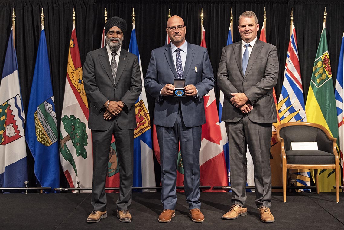 The Honourable Harjit S. Sajjan, President of the King's Privy Council for Canada and Minister of Emergency Preparedness (far left) and Minister responsible for the Pacific Economic Development Agency of Canada, and the Honourable Bloyce Thompson, Deputy Premier, Minister of Justice and Public Safety and Attorney General for Prince Edward Island (far right) are pictured with the 2022 award recipient of the Emergency Management Exemplary Service Award for the Outstanding Contribution to Emergency Management category.