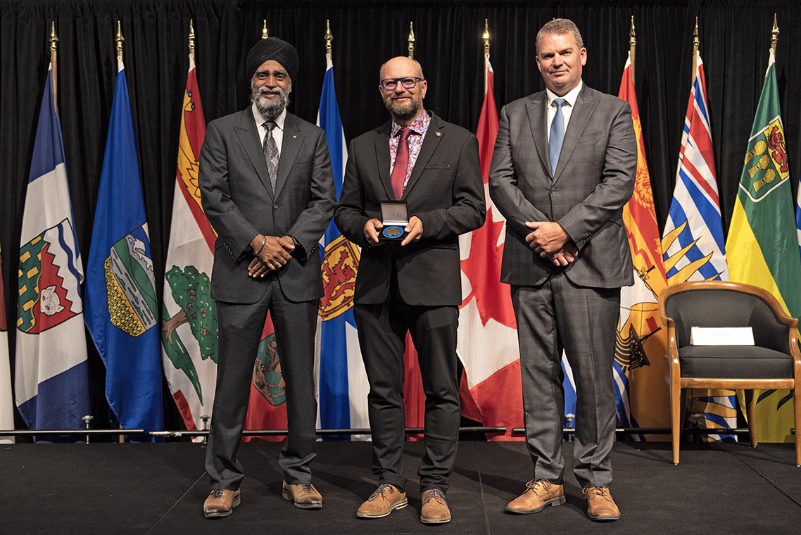 The Honourable Harjit S. Sajjan, President of the King's Privy Council for Canada and Minister of Emergency Preparedness (far left) and Minister responsible for the Pacific Economic Development Agency of Canada, and the Honourable Bloyce Thompson, Deputy Premier, Minister of Justice and Public Safety and Attorney General for Prince Edward Island (far right) are pictured with the 2022 award recipient of the Emergency Management Exemplary Service Award for the Outstanding Contribution to Emergency Management category.