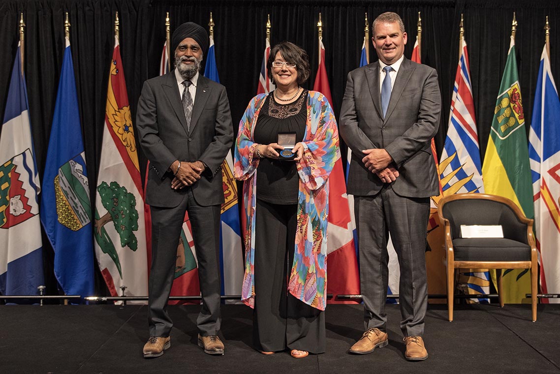 The Honourable Harjit S. Sajjan, President of the King's Privy Council for Canada and Minister of Emergency Preparedness (far left) and Minister responsible for the Pacific Economic Development Agency of Canada, and the Honourable Bloyce Thompson, Deputy Premier, Minister of Justice and Public Safety and Attorney General for Prince Edward Island (far right) are pictured with the 2022 award recipient of the Emergency Management Exemplary Service Award for the Outstanding Contribution to Emergency Management category.