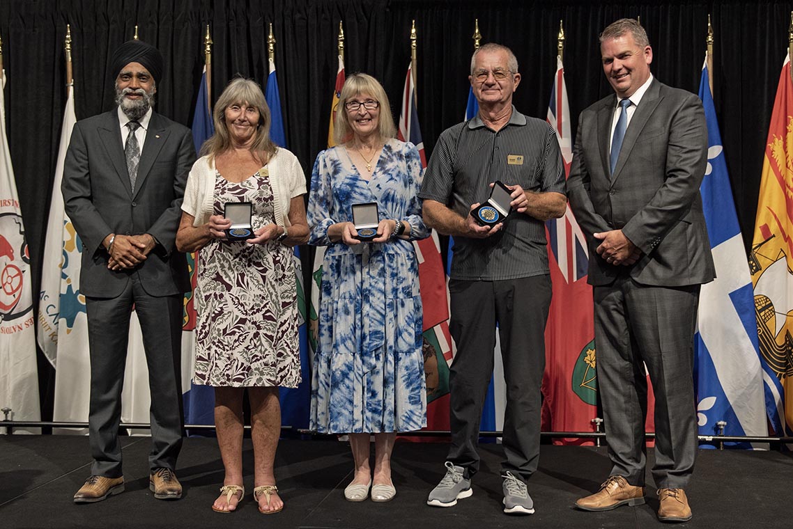 The Honourable Harjit S. Sajjan, President of the King's Privy Council for Canada and Minister of Emergency Preparedness (far left) and Minister responsible for the Pacific Economic Development Agency of Canada, and the Honourable Bloyce Thompson, Deputy Premier, Minister of Justice and Public Safety and Attorney General for Prince Edward Island (far right) are pictured with the 2022 award recipient of the Emergency Management Exemplary Service Award for the Outstanding Contribution to Emergency Management category.