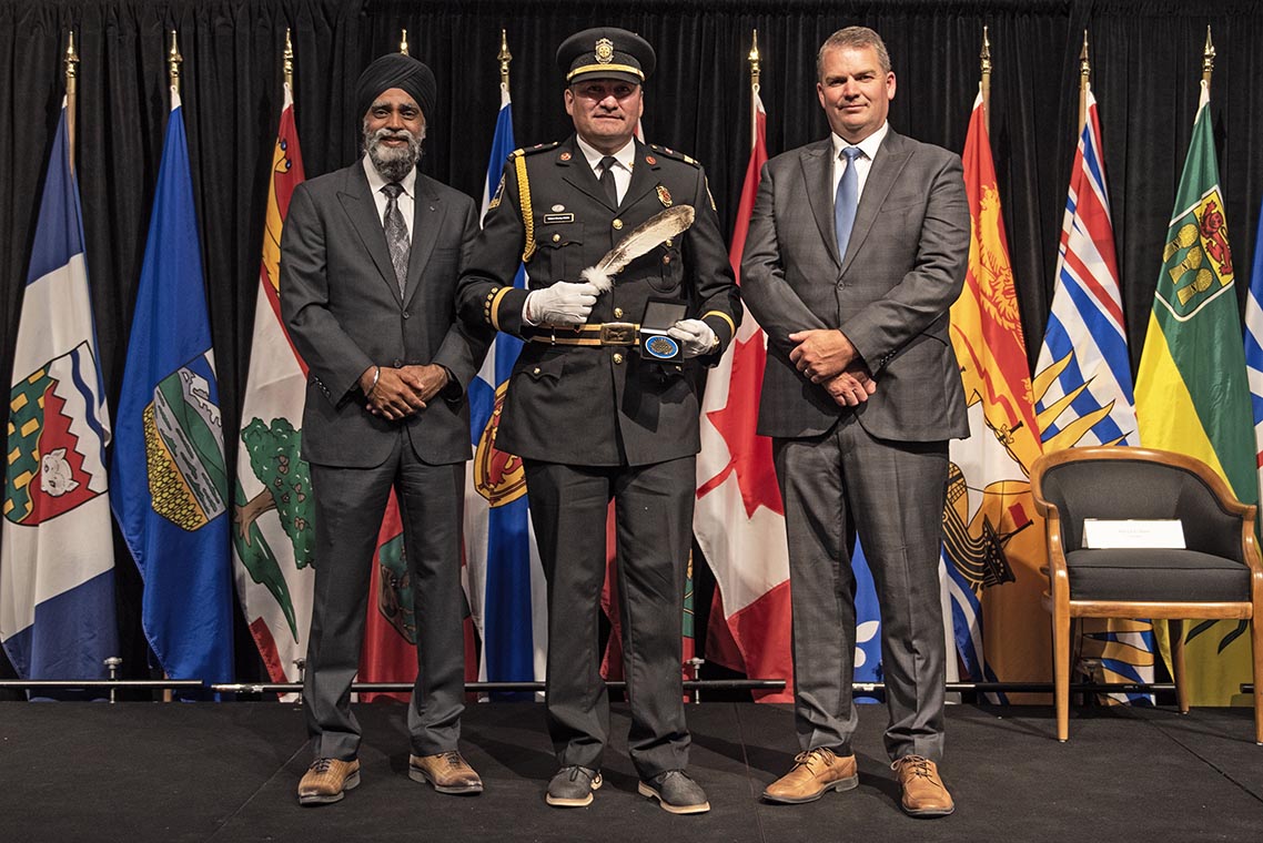 The Honourable Harjit S. Sajjan, President of the King's Privy Council for Canada and Minister of Emergency Preparedness (far left) and Minister responsible for the Pacific Economic Development Agency of Canada, and the Honourable Bloyce Thompson, Deputy Premier, Minister of Justice and Public Safety and Attorney General for Prince Edward Island (far right) are pictured with the 2022 award recipient of the Emergency Management Exemplary Service Award for the Outstanding Contribution to Emergency Management category.