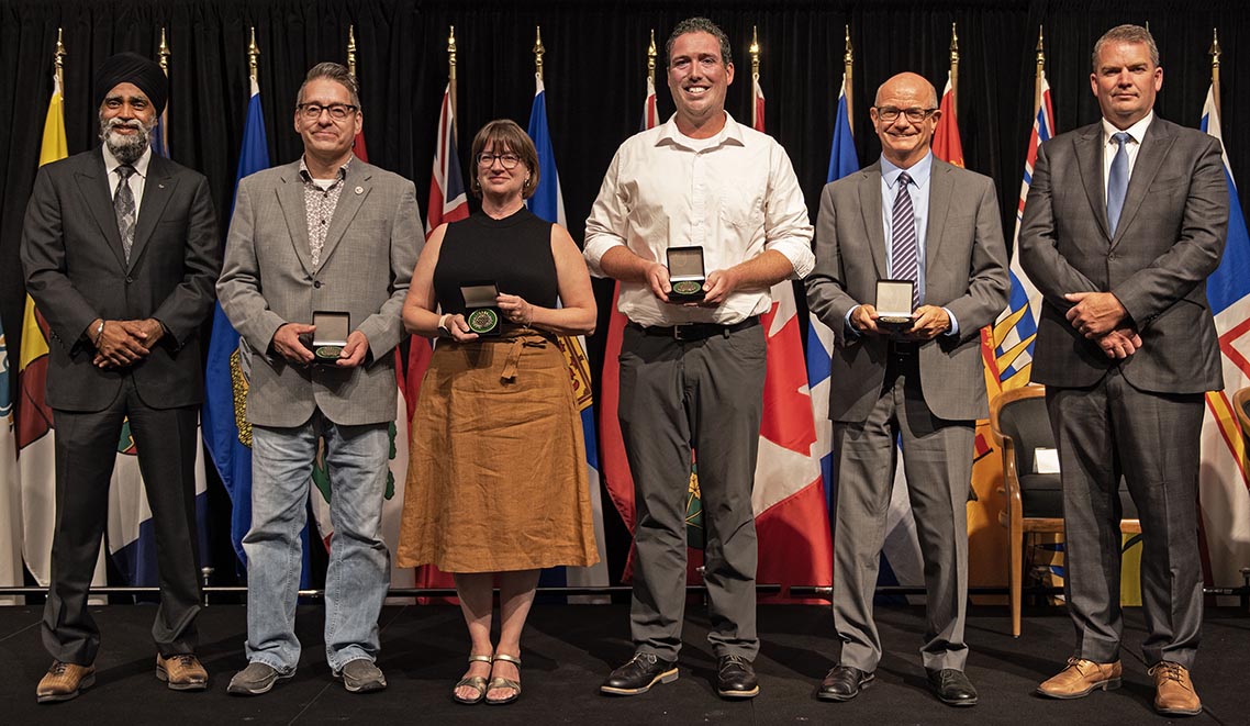 The Honourable Harjit S. Sajjan, President of the King's Privy Council for Canada and Minister of Emergency Preparedness (far left) and Minister responsible for the Pacific Economic Development Agency of Canada, and the Honourable Bloyce Thompson, Deputy Premier, Minister of Justice and Public Safety and Attorney General for Prince Edward Island (far right) are pictured with the 2022 award recipient of the Emergency Management Exemplary Service Award for the Resilient Communities category.