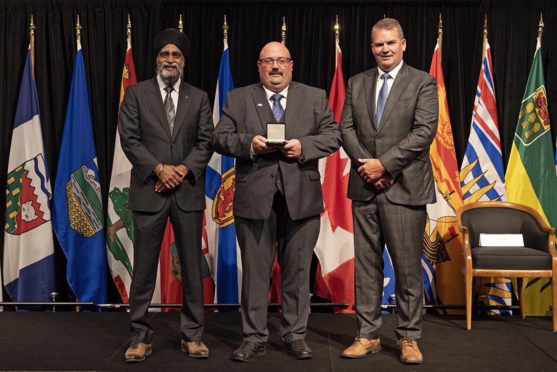The Honourable Harjit S. Sajjan, President of the King's Privy Council for Canada and Minister of Emergency Preparedness (far left) and Minister responsible for the Pacific Economic Development Agency of Canada, and the Honourable Bloyce Thompson, Deputy Premier, Minister of Justice and Public Safety and Attorney General for Prince Edward Island (far right) are pictured with the 2022 award recipient of the Emergency Management Exemplary Service Award for the Resilient Communities category.