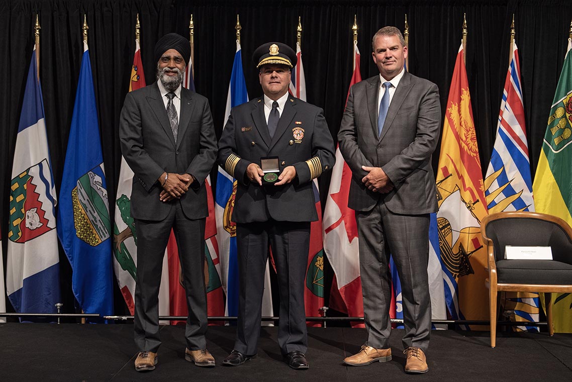 The Honourable Harjit S. Sajjan, President of the King's Privy Council for Canada and Minister of Emergency Preparedness (far left) and Minister responsible for the Pacific Economic Development Agency of Canada, and the Honourable Bloyce Thompson, Deputy Premier, Minister of Justice and Public Safety and Attorney General for Prince Edward Island (far right) are pictured with the 2022 award recipient of the Emergency Management Exemplary Service Award for the Resilient Communities category.